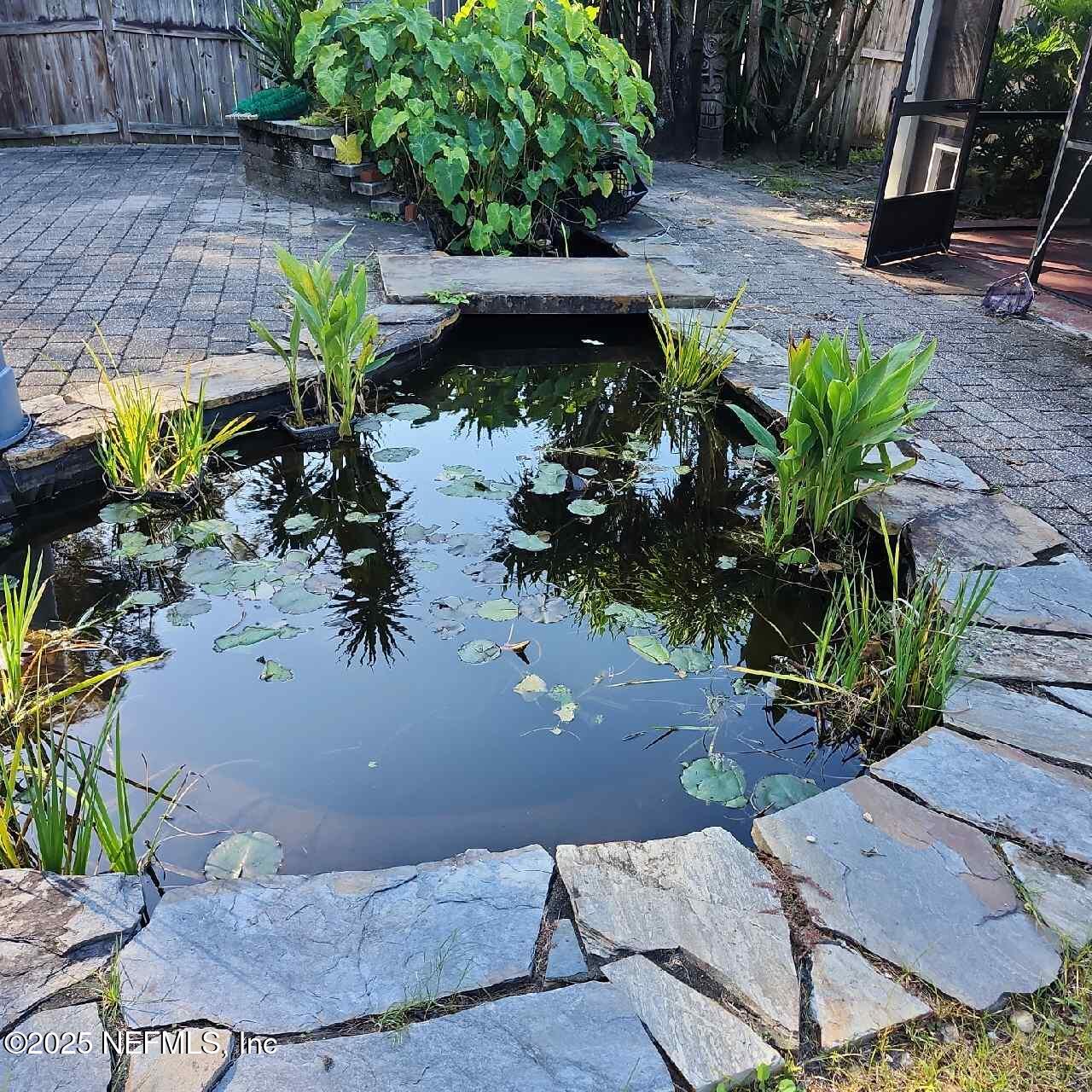 96203 Ridgewood Circle Fernandina Beach, FL 32034 - Photo 5 of 20 a view of a backyard with plants and a patio