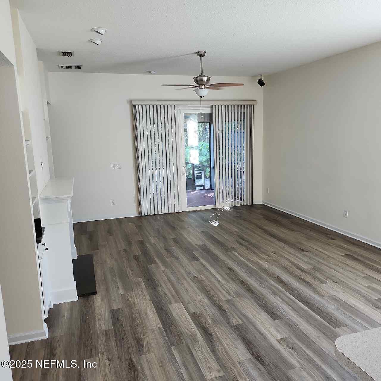 96203 Ridgewood Circle Fernandina Beach, FL 32034 - Photo 6 of 20 wooden floor in an empty room with a window