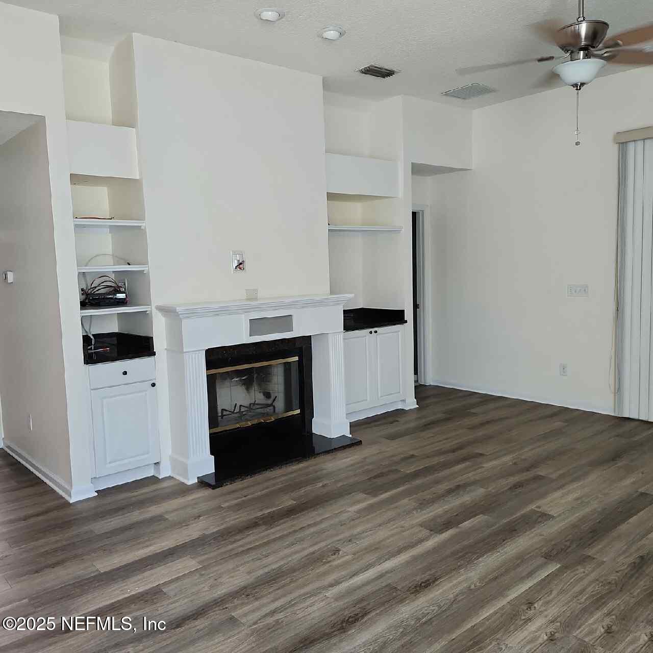 96203 Ridgewood Circle Fernandina Beach, FL 32034 - Photo 7 of 20 a view of kitchen and empty room with wooden floor