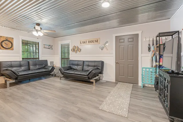 an aerial view of a house with a yard and lake view