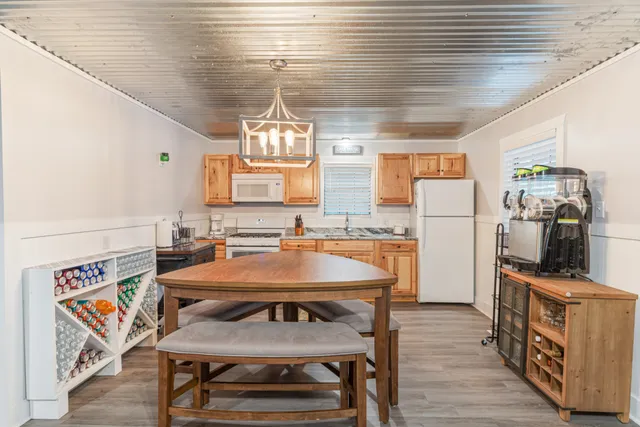 an aerial view of a houses with a yard and lake view