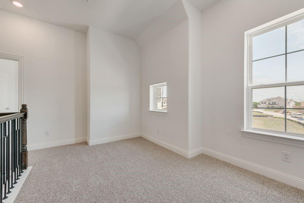 248 Golden Run Drive Fate, TX 75189 - Photo 18 of 34 an empty room with windows