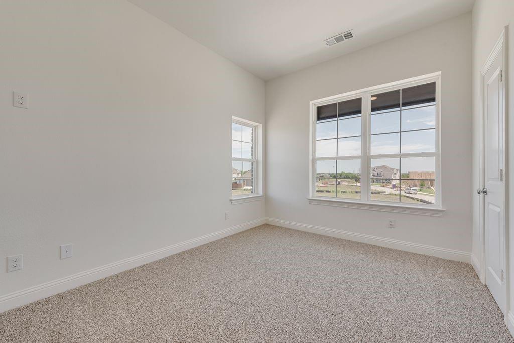 248 Golden Run Drive Fate, TX 75189 - Photo 21 of 34 an empty room with windows