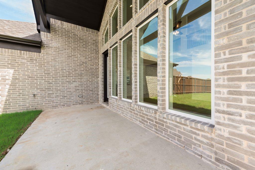 248 Golden Run Drive Fate, TX 75189 - Photo 24 of 34 a view of a brick house with a large window