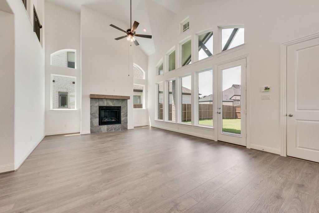 248 Golden Run Drive Fate, TX 75189 - Photo 3 of 34 a view of an empty room with a fireplace and a window