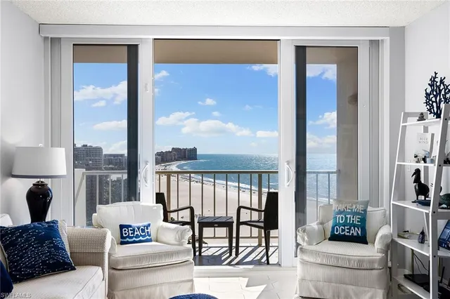 a living room with furniture and a floor to ceiling window