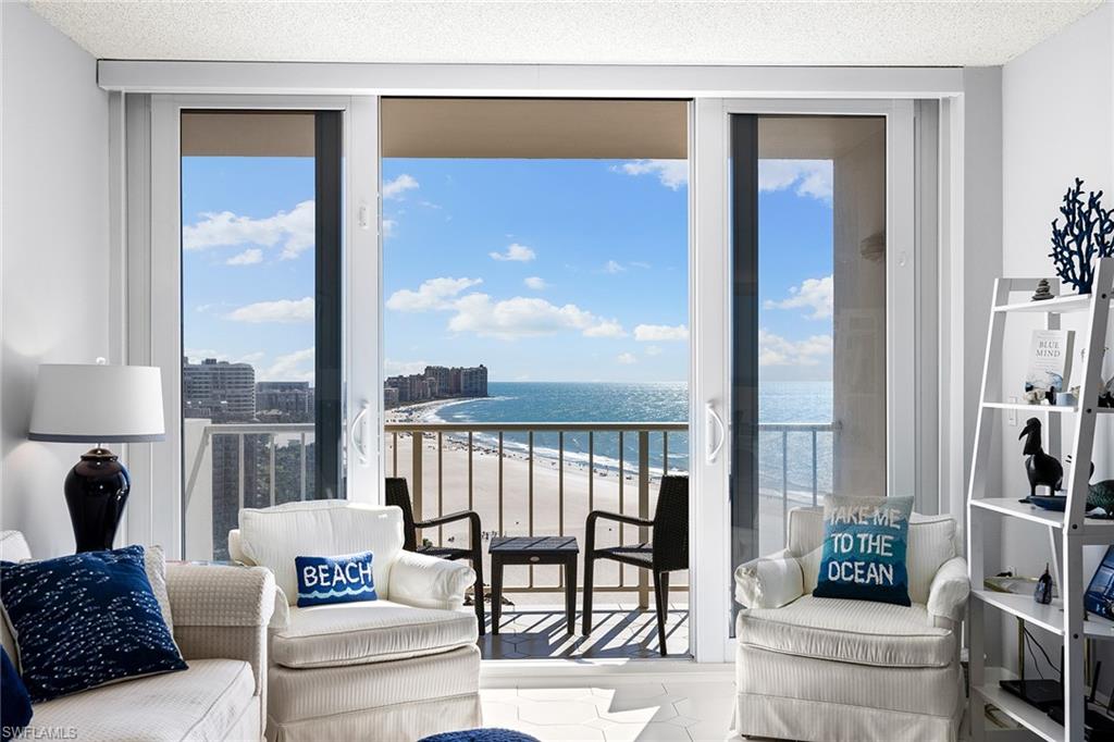 a living room with furniture and a floor to ceiling window