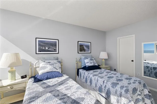 a bedroom with a bed and a lamp