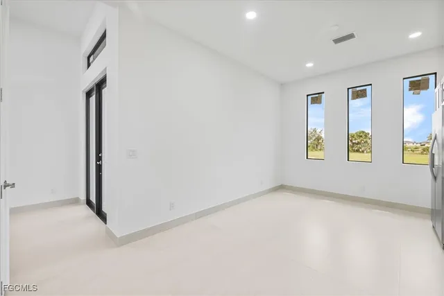 a kitchen with white cabinets and white appliances