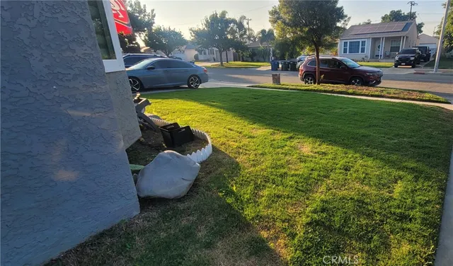 a view of a garden with lawn chairs and a fire pit