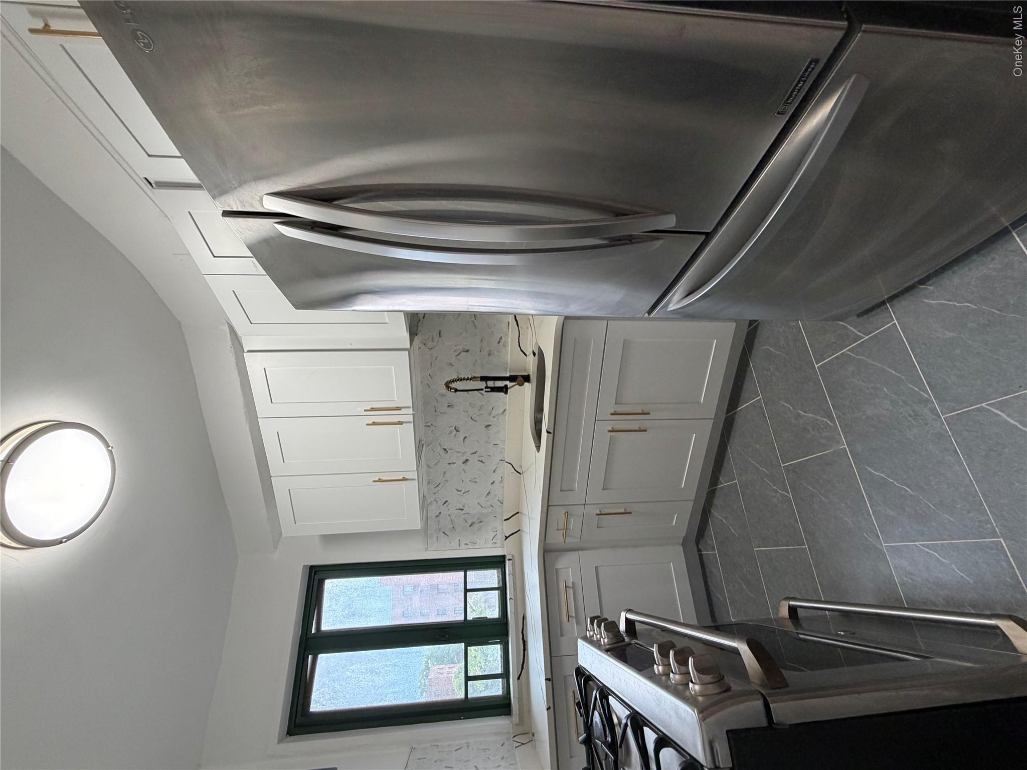 1503 Metropolitan Avenue, Unit 4F Bronx, NY 10462 - Photo 5 of 7 a kitchen with appliances cabinets and a sink