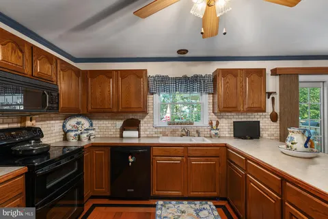 a kitchen with a sink stove and microwave