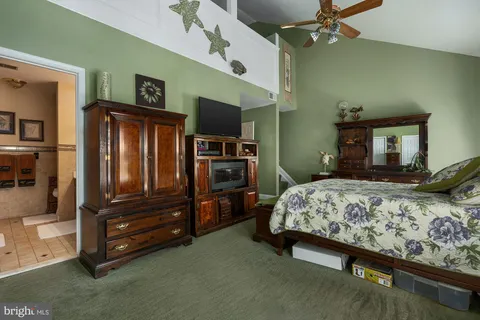 a bedroom with a bed and a television in it