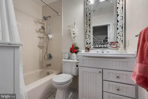 a bedroom with a bed and a dresser in it