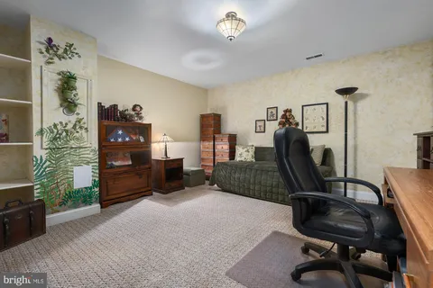 a living room with furniture and view of kitchen