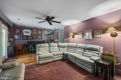 a room with furniture a fireplace and a flat screen tv