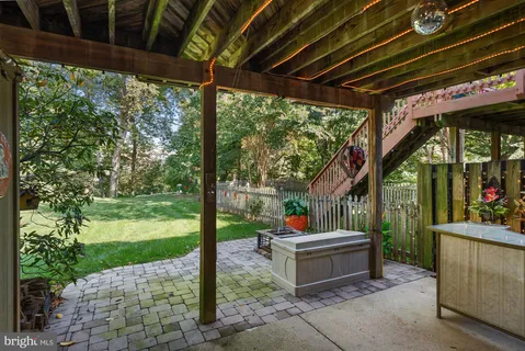 a view of a house with a yard and sitting area