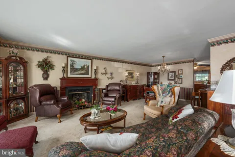 a living room with furniture a rug and a fireplace