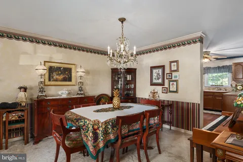 a view of a dining room with furniture and chandelier