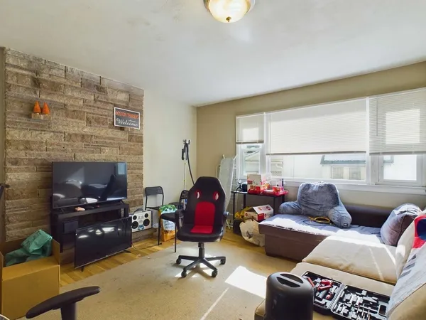 a living room with furniture fireplace and a window