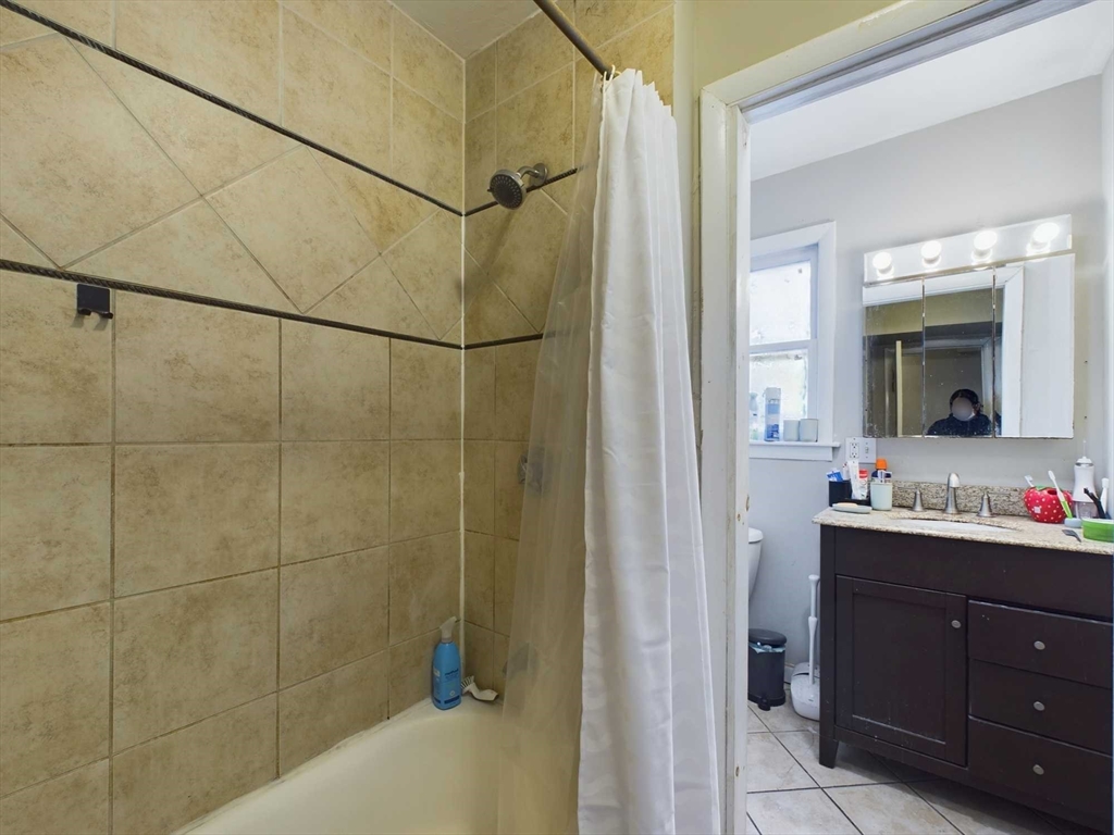 24 Chester Street Boston, MA 02134 - Photo 14 of 23 a bathroom with a double vanity sink and mirror with shower