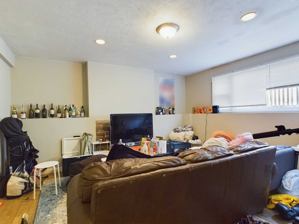 24 Chester Street Boston, MA 02134 - Photo 18 of 23 a living room with furniture and a flat screen tv