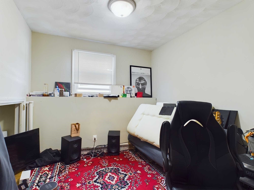 24 Chester Street Boston, MA 02134 - Photo 20 of 23 a bed room with a bed and a television