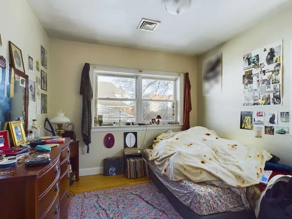 a bedroom with a bed and a window