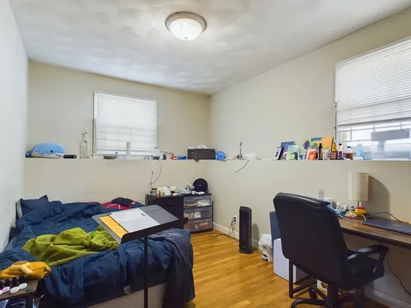 a bed room with a bed and a chair