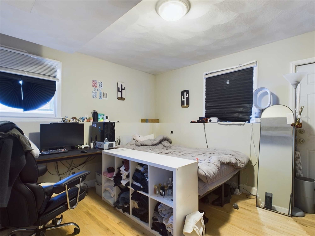 24 Chester Street Boston, MA 02134 - Photo 22 of 23 a bed room with a bed and a television