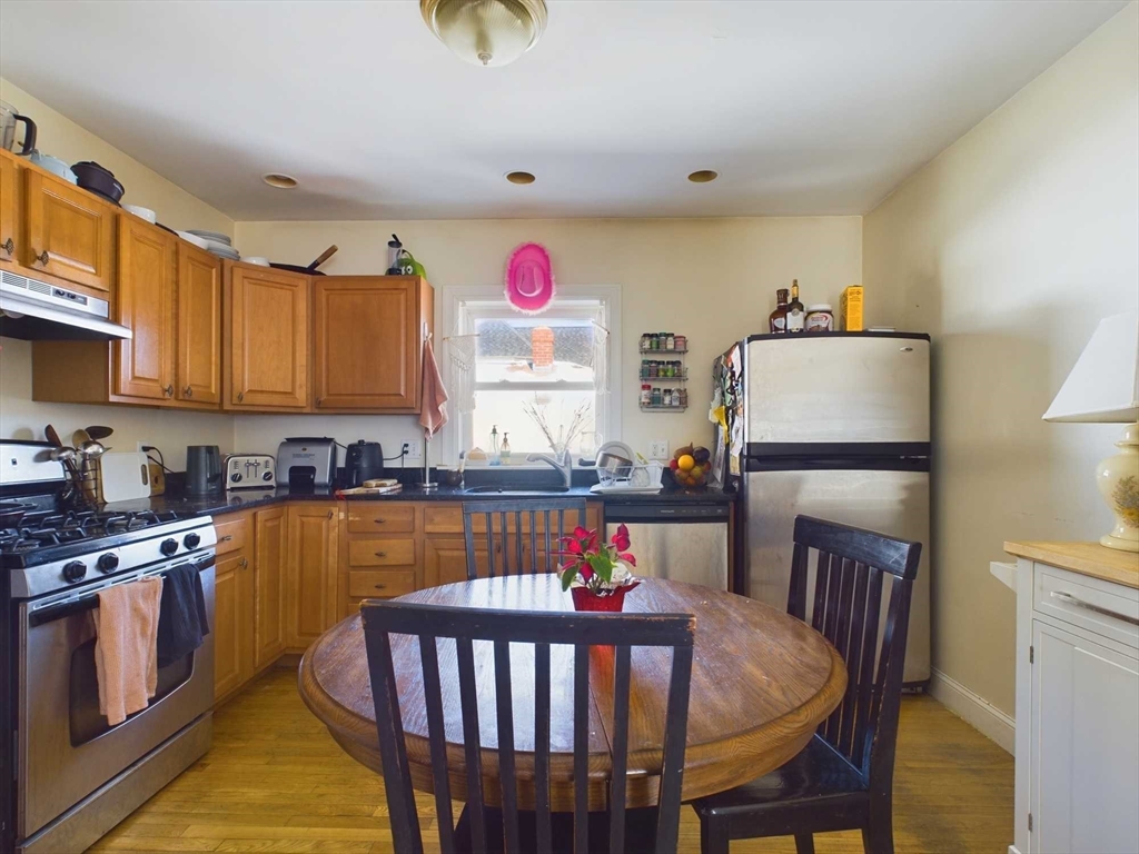24 Chester Street Boston, MA 02134 - Photo 4 of 23 a kitchen that has a table and chairs in it
