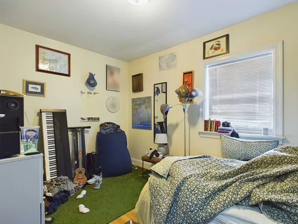 a bed room with a bed mirror and a table