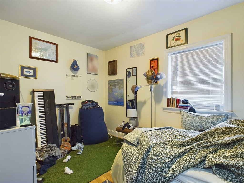 24 Chester Street Boston, MA 02134 - Photo 8 of 23 a bed room with a bed mirror and a table