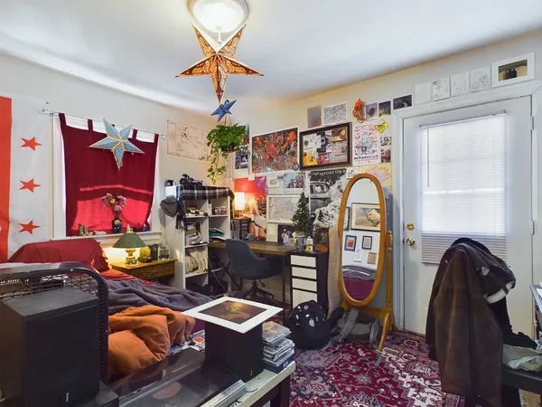 a bedroom with a bed and a chandelier