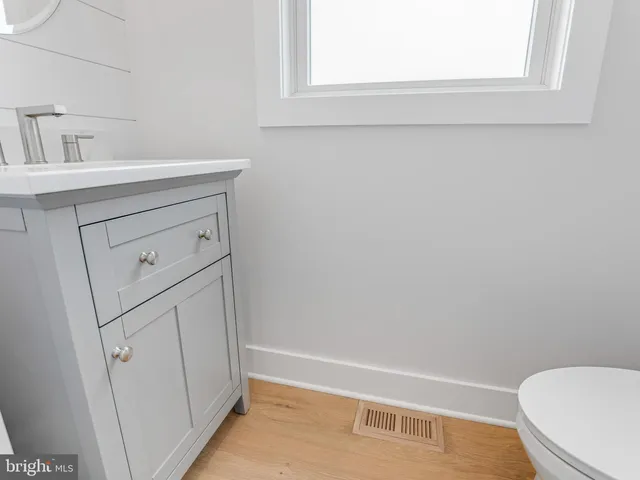 a spacious bedroom with a bed a couch and a window