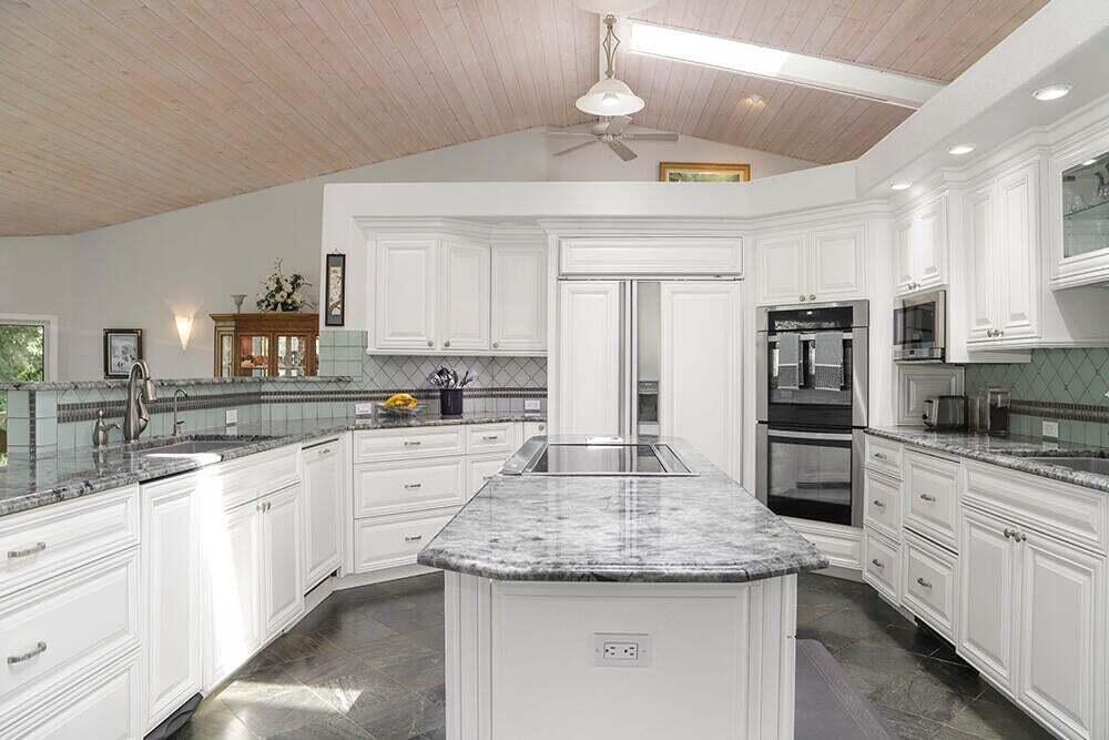 4118 Leonard Road Grants Pass, OR 97527 - Photo 12 of 37 a kitchen with stainless steel appliances granite countertop a sink refrigerator and cabinets