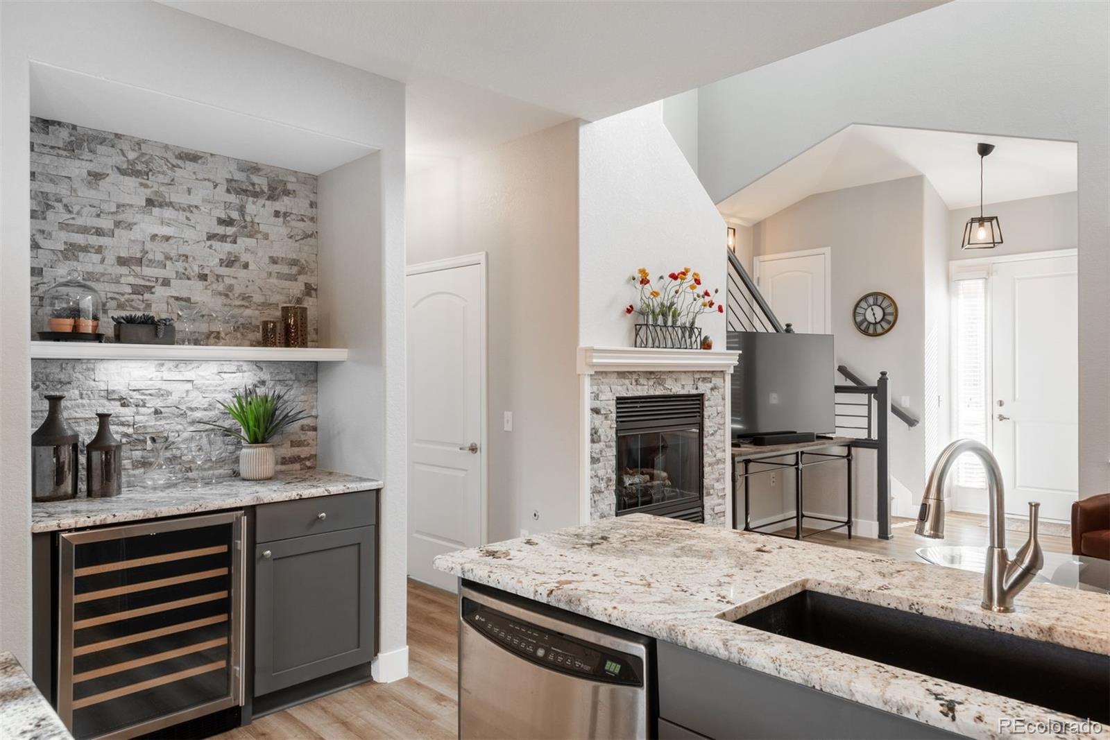 8555 Gold Peak Drive, Unit B Highlands Ranch, CO 80130 - Photo 13 of 38 a kitchen with a stove and a wooden floor