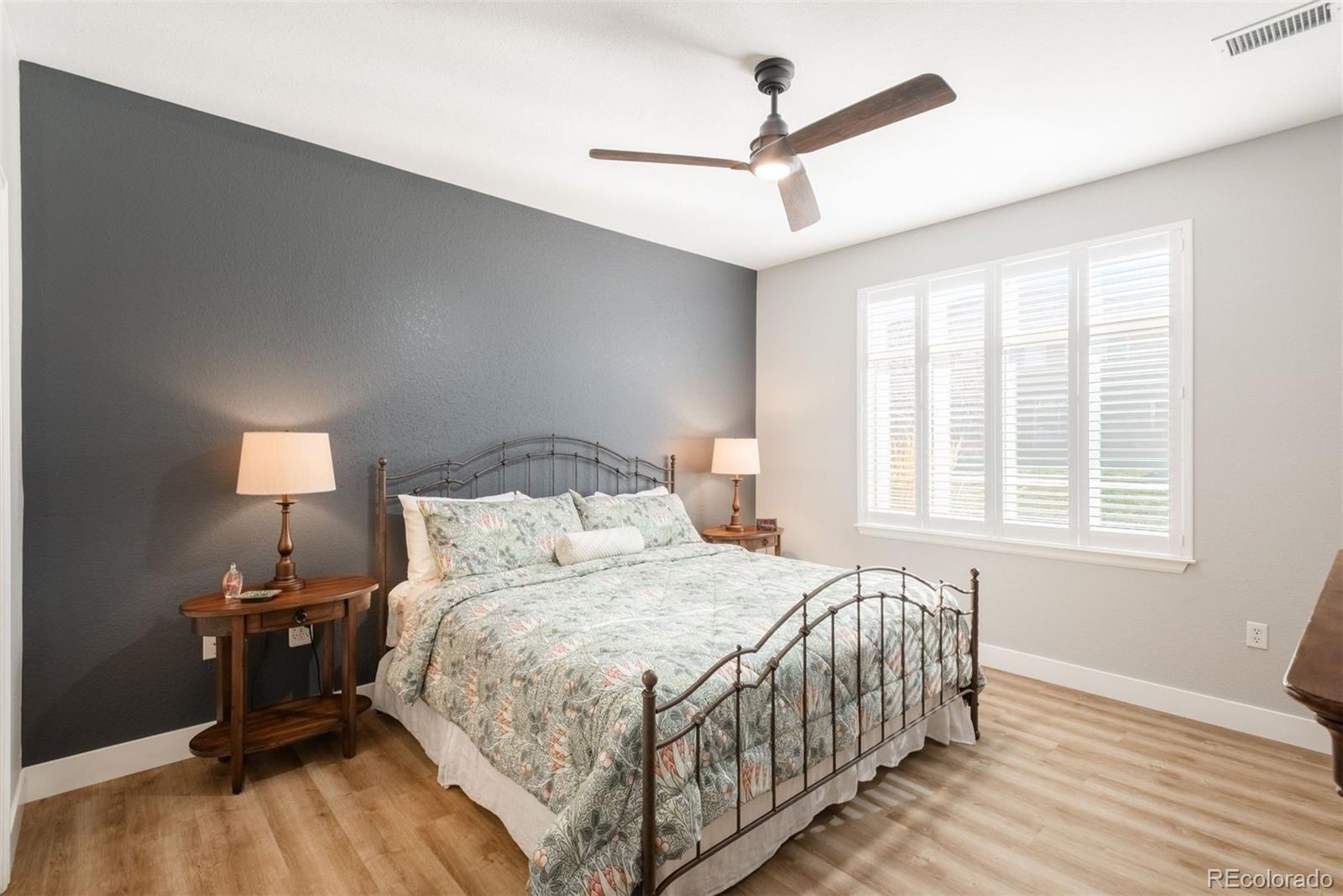 8555 Gold Peak Drive, Unit B Highlands Ranch, CO 80130 - Photo 14 of 38 a bedroom with a bed and a window