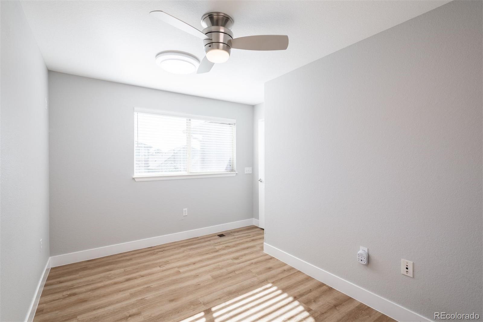 8555 Gold Peak Drive, Unit B Highlands Ranch, CO 80130 - Photo 24 of 38 a view of a room with a window and a ceiling fan