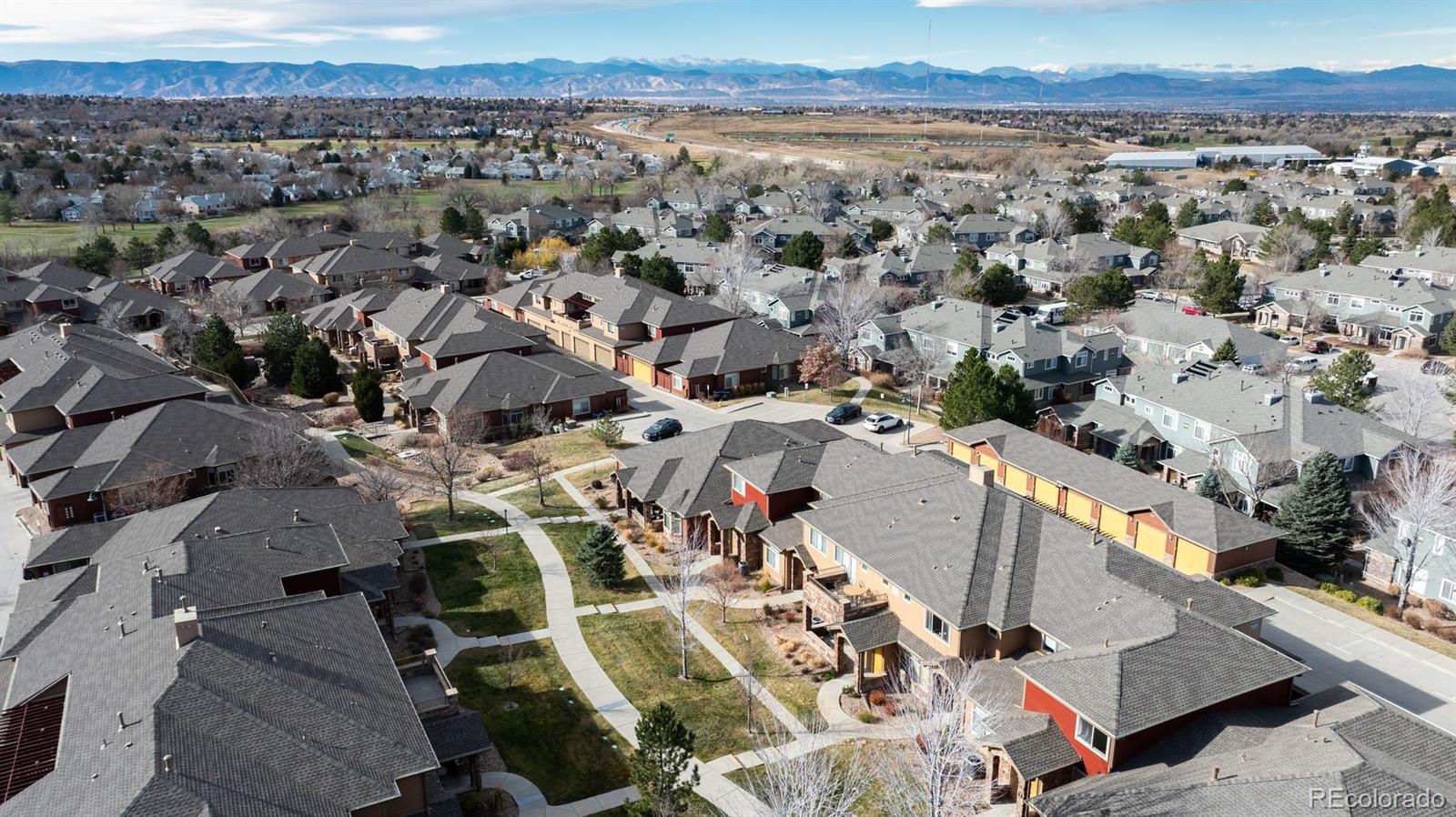 8555 Gold Peak Drive, Unit B Highlands Ranch, CO 80130 - Photo 35 of 38 an aerial view of a city with lots of residential buildings