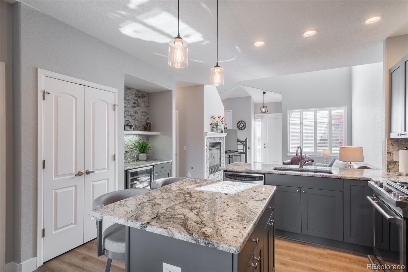 8555 Gold Peak Drive, Unit B Highlands Ranch, CO 80130 - Photo 7 of 38 a kitchen with center island and stainless steel appliances