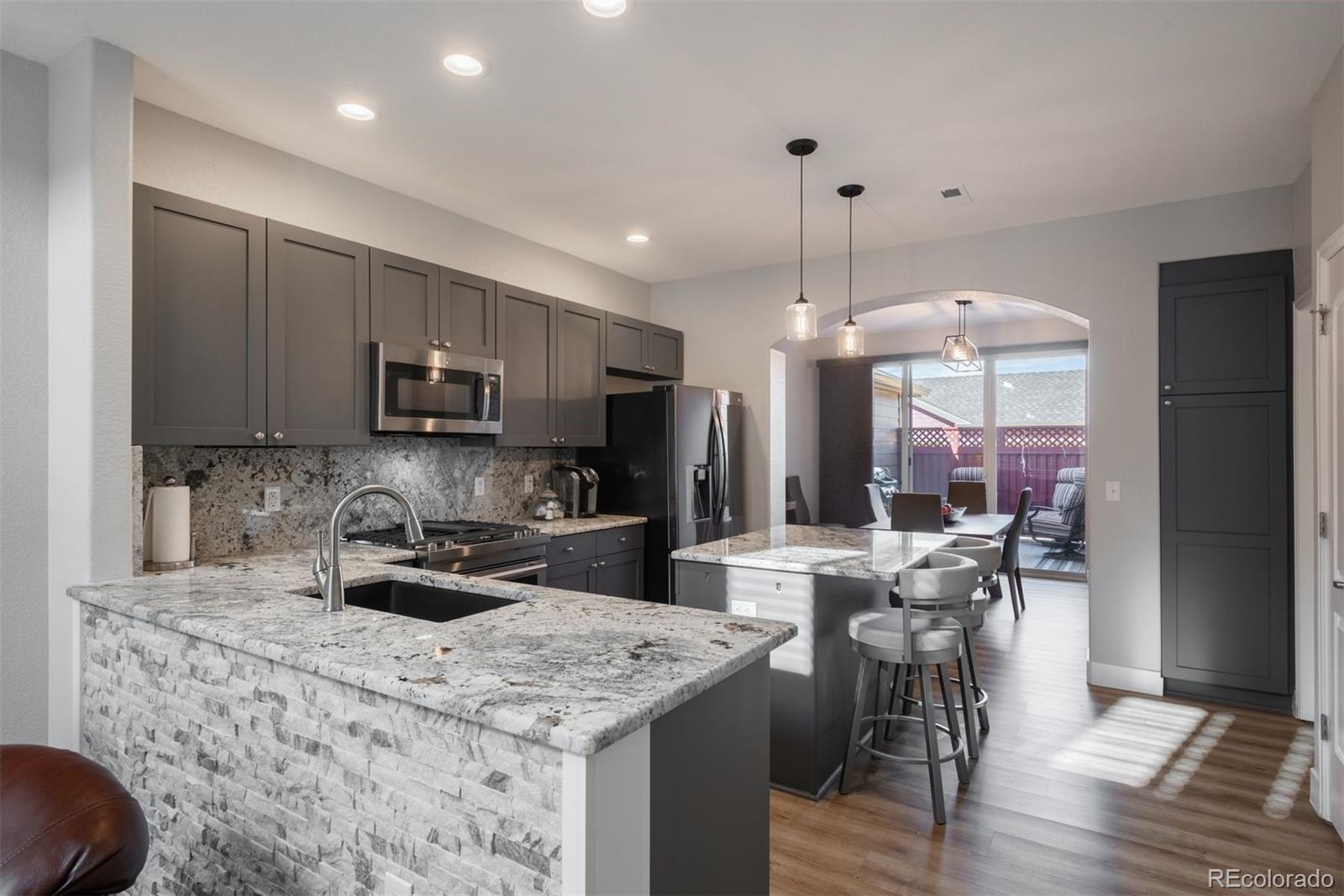 8555 Gold Peak Drive, Unit B Highlands Ranch, CO 80130 - Photo 8 of 38 a kitchen with counter top space cabinets and appliances