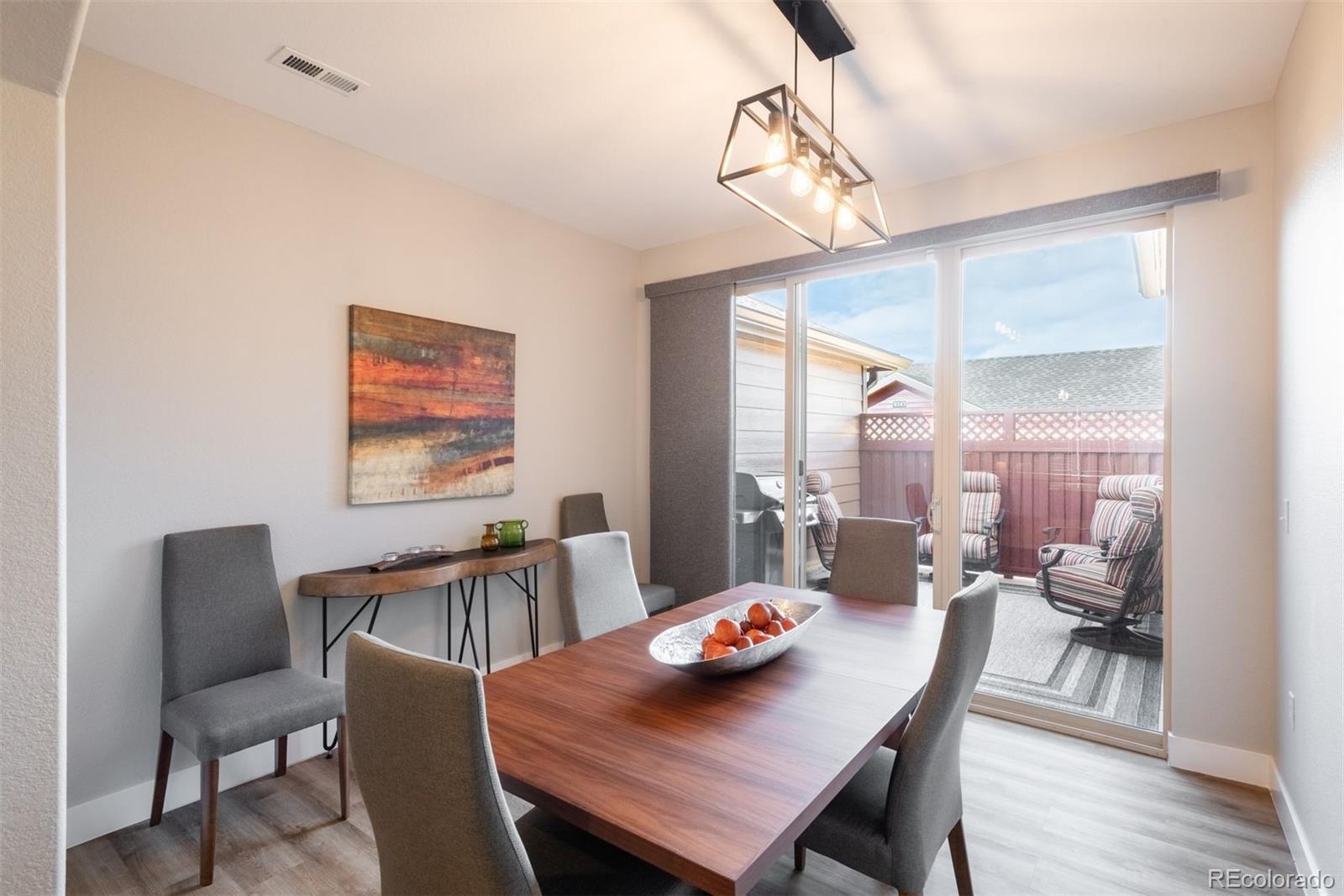 8555 Gold Peak Drive, Unit B Highlands Ranch, CO 80130 - Photo 10 of 38 a view of a dining room with furniture window and wooden floor