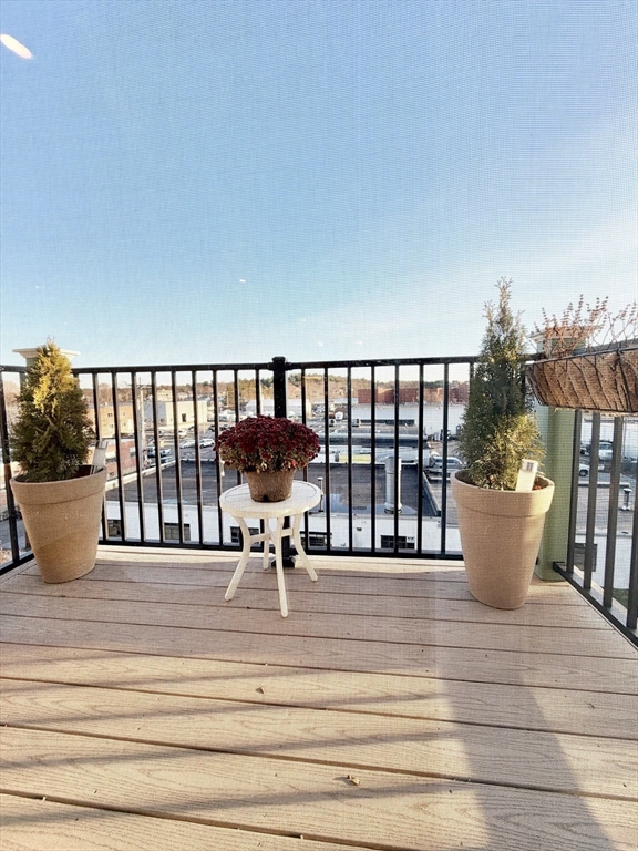 69 Foundry Street, Unit 416 Wakefield, MA 01880 - Photo 12 of 21 a view of a chairs and table on the terrace