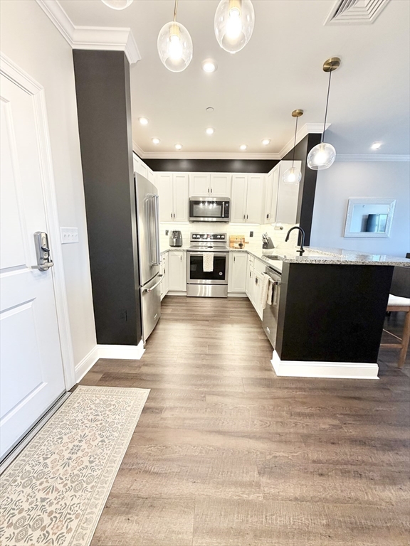 69 Foundry Street, Unit 416 Wakefield, MA 01880 - Photo 3 of 21 a view of kitchen with sink microwave and refrigerator
