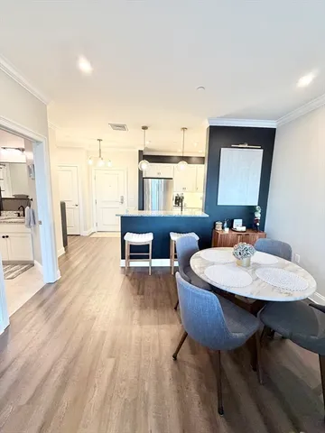 a living room with furniture a table and wooden floor