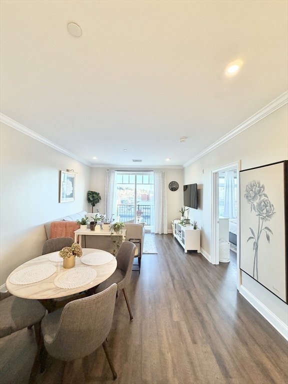 69 Foundry Street, Unit 416 Wakefield, MA 01880 - Photo 8 of 21 a living room with furniture and a table