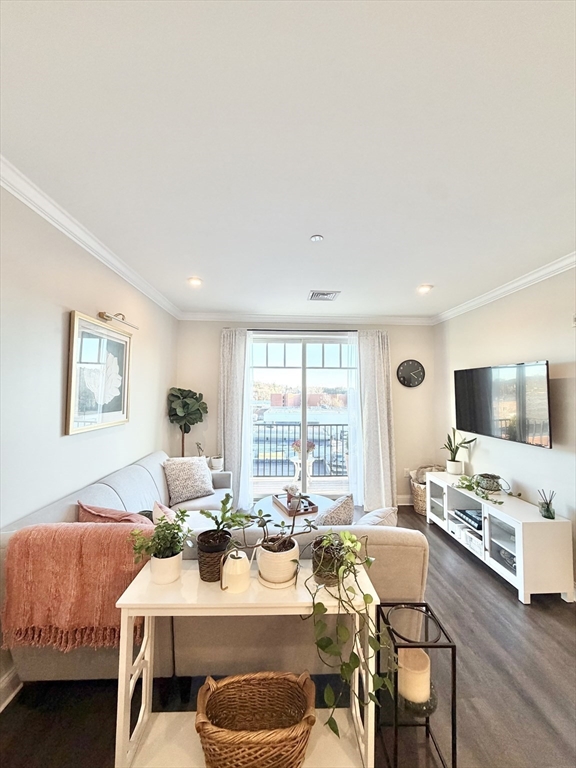 69 Foundry Street, Unit 416 Wakefield, MA 01880 - Photo 9 of 21 a living room with furniture a flat screen tv and a large window