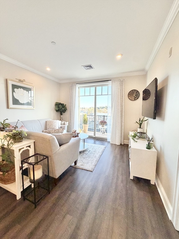 69 Foundry Street, Unit 416 Wakefield, MA 01880 - Photo 10 of 21 a living room with furniture and wooden floor