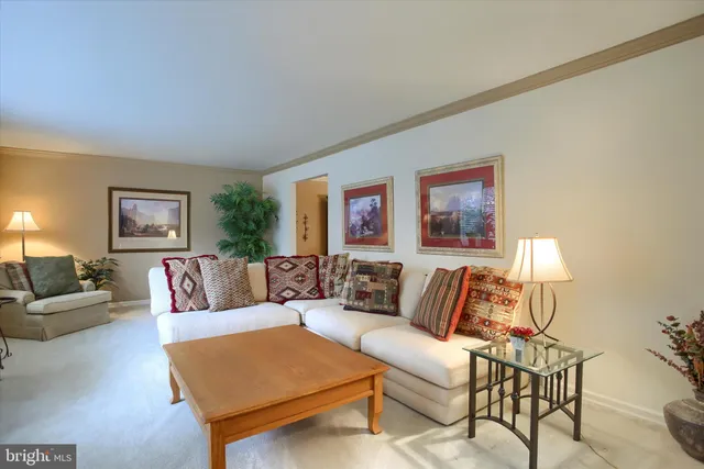 a living room with furniture and a night stand